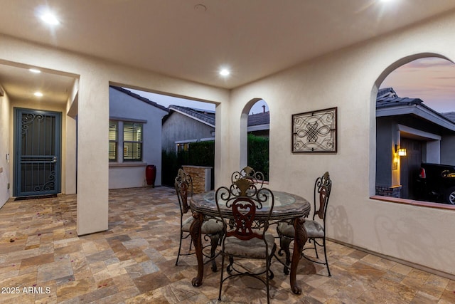 20784 W Minnezona Ave, Buckeye, AZ 85396 - dining room with stone tile floors, arched walkways, and recessed lighting