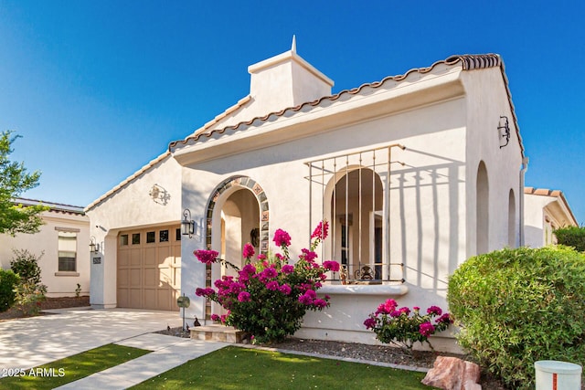 20784 W Minnezona Ave, Buckeye, AZ 85396 - mediterranean / spanish-style home with driveway, a garage, stucco siding, and a tiled roof