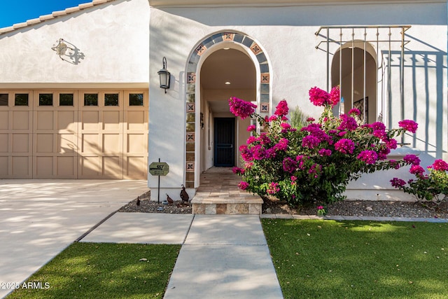 20784 W Minnezona Ave, Buckeye, AZ 85396 - view of front of property with a garage, stucco siding, and concrete driveway