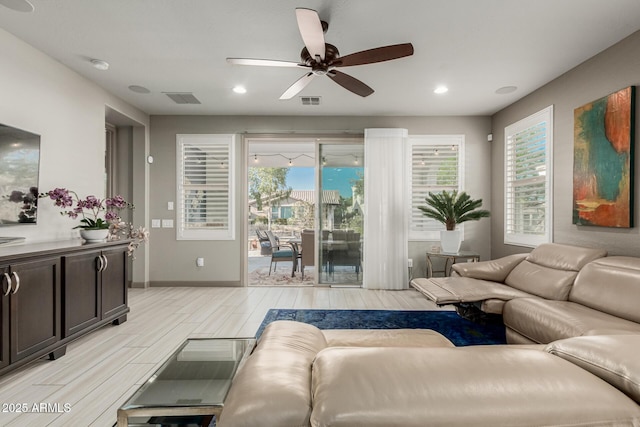 20784 W Minnezona Ave, Buckeye, AZ 85396 - living area with light wood-style floors, a ceiling fan, plenty of natural light, recessed lighting, and baseboards