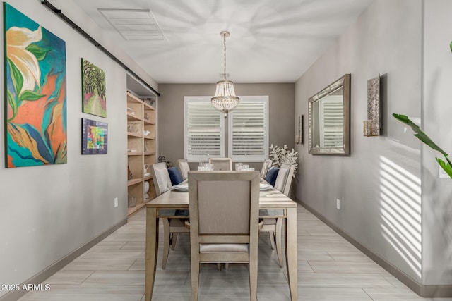 20784 W Minnezona Ave, Buckeye, AZ 85396 - dining room featuring a chandelier, baseboards, and wood tiled floors