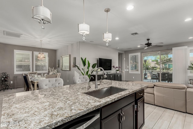 20784 W Minnezona Ave, Buckeye, AZ 85396 - kitchen with a sink, open floor plan, recessed lighting, ceiling fan, and light stone counters