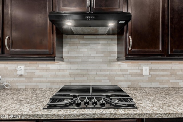 20784 W Minnezona Ave, Buckeye, AZ 85396 - kitchen with black gas cooktop, dark brown cabinetry, and extractor fan