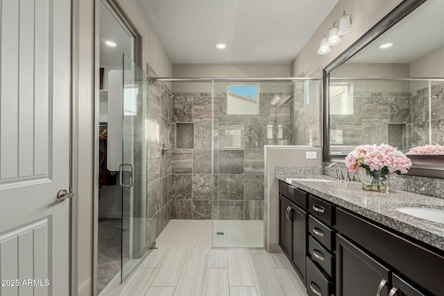 20784 W Minnezona Ave, Buckeye, AZ 85396 - full bathroom featuring a stall shower, double vanity, and recessed lighting