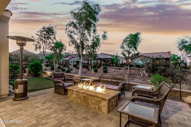 20784 W Minnezona Ave, Buckeye, AZ 85396 - view of patio / terrace with a putting green, a residential view, and an outdoor living space with a fire pit