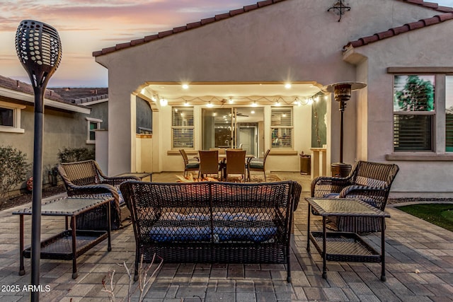 20784 W Minnezona Ave, Buckeye, AZ 85396 - patio terrace at dusk featuring a patio area, an outdoor living space, and outdoor dining space