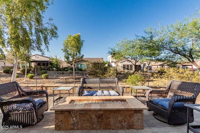 20784 W Minnezona Ave, Buckeye, AZ 85396 - view of patio / terrace featuring a fire pit and a residential view