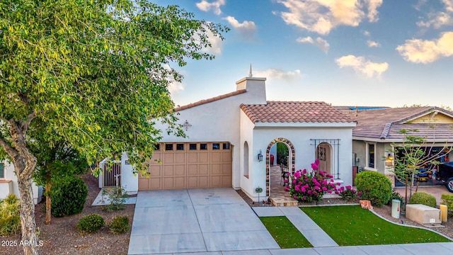 20784 W Minnezona Ave, Buckeye, AZ 85396 - mediterranean / spanish home with an attached garage, a tiled roof, driveway, stucco siding, and a chimney