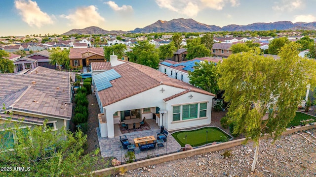 20784 W Minnezona Ave, Buckeye, AZ 85396 - back of property with a putting area, an outdoor living space, a patio area, a tiled roof, and stucco siding