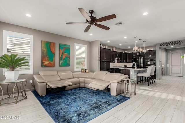 20784 W Minnezona Ave, Buckeye, AZ 85396 - living room with a ceiling fan, wood finish floors, baseboards, and recessed lighting