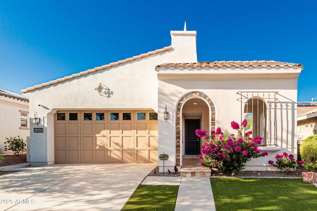 20784 W Minnezona Ave, Buckeye, AZ 85396 - mediterranean / spanish home with a garage, a tile roof, driveway, and stucco siding