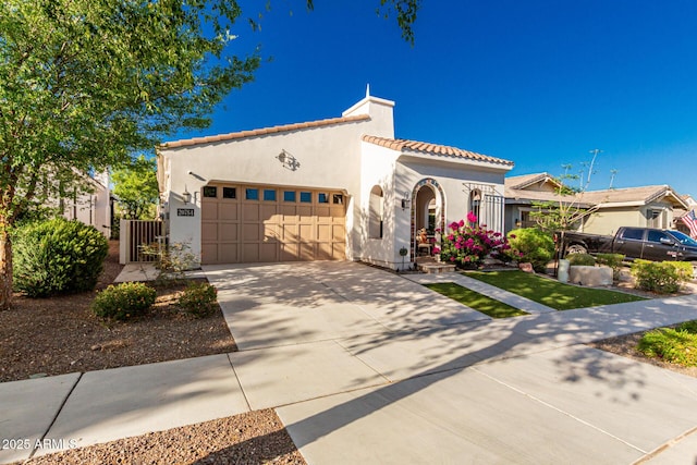 20784 W Minnezona Ave, Buckeye, AZ 85396 - mediterranean / spanish-style house featuring a tile roof, a garage, stucco siding, and driveway