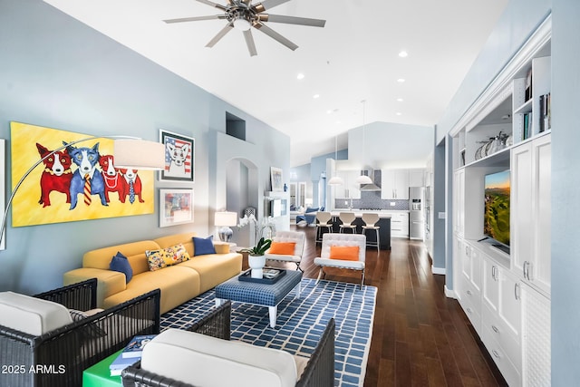 living room featuring ceiling fan, high vaulted ceiling, and dark hardwood / wood-style flooring