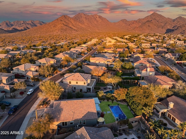 aerial view at dusk featuring a mountain view