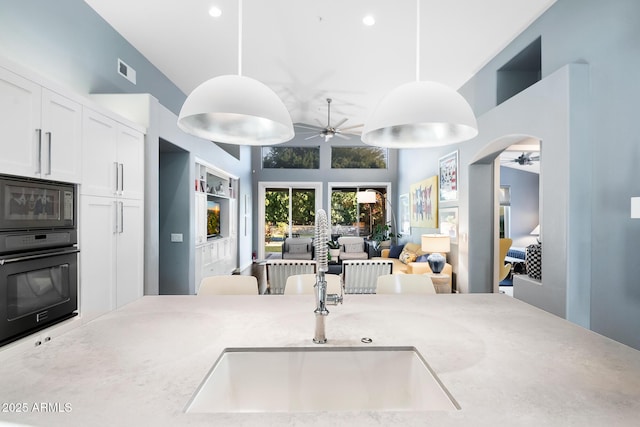 interior space featuring sink and ceiling fan