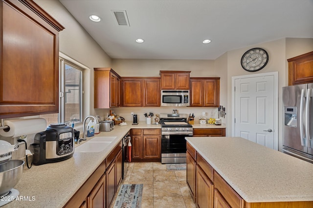 kitchen featuring appliances with stainless steel finishes, sink, and a kitchen island