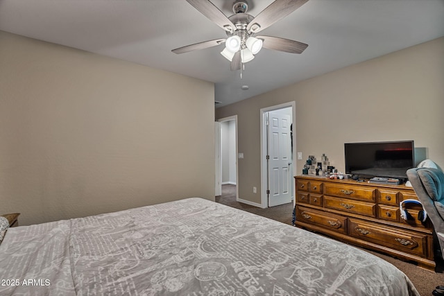 bedroom with ceiling fan and dark carpet