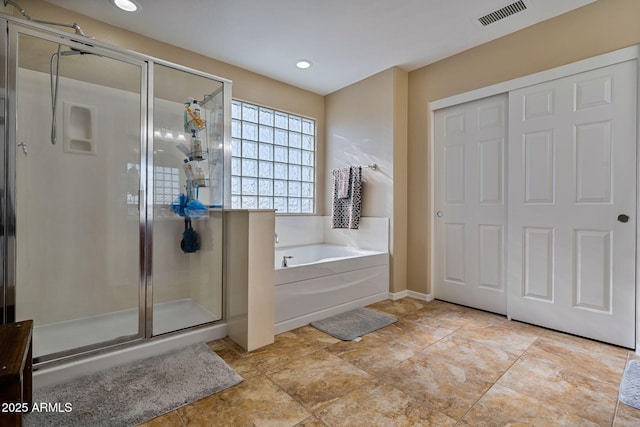 bathroom featuring independent shower and bath