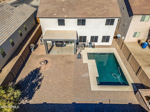 view of pool featuring a patio area and a fire pit