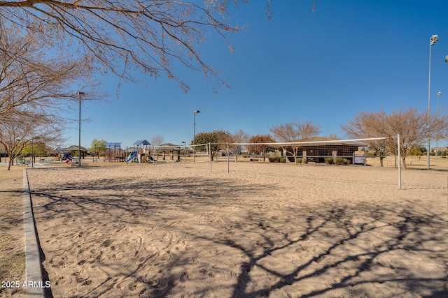 view of property's community with a playground and volleyball court