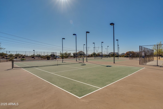 view of tennis court with basketball hoop