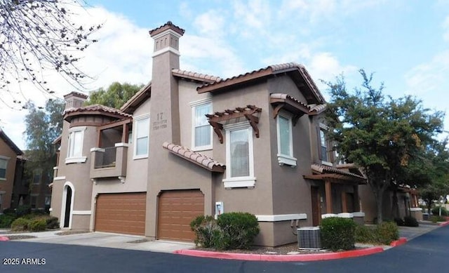 14250 W Wigwam Blvd Unit 1723, Litchfield Park, AZ 85340 - view of front of property featuring a chimney, an attached garage, a tile roof, and stucco siding
