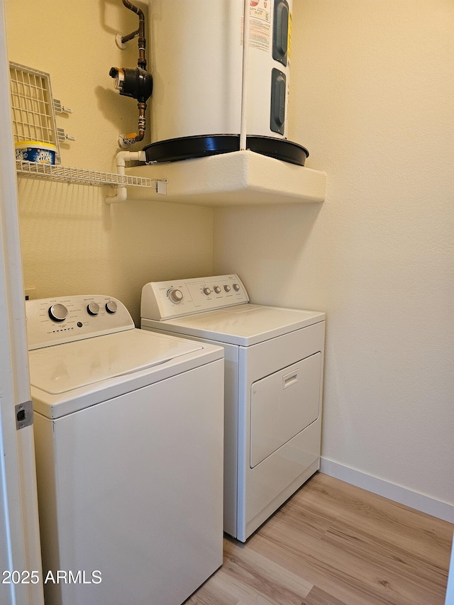 14250 W Wigwam Blvd Unit 1723, Litchfield Park, AZ 85340 - laundry area featuring washing machine and clothes dryer, water heater, and light wood-style flooring