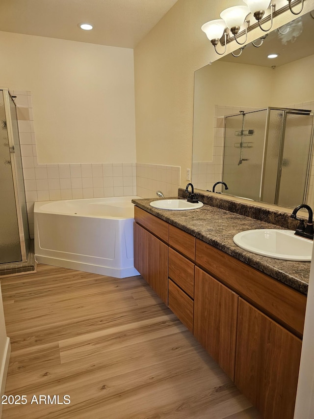 14250 W Wigwam Blvd Unit 1723, Litchfield Park, AZ 85340 - bathroom with a shower stall, a bath, wood finished floors, double vanity, and recessed lighting