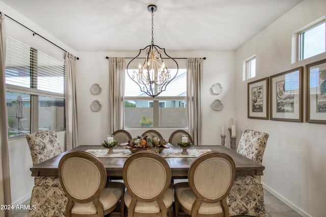 dining room featuring a chandelier and light tile patterned floors