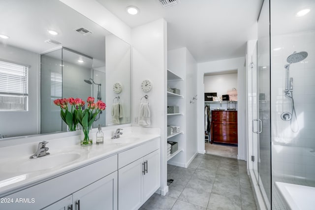 bathroom featuring tile patterned floors, vanity, and walk in shower