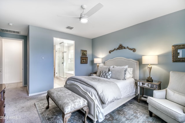 carpeted bedroom featuring ensuite bath and ceiling fan