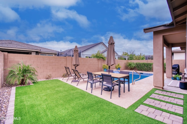 view of yard with a fenced in pool and a patio