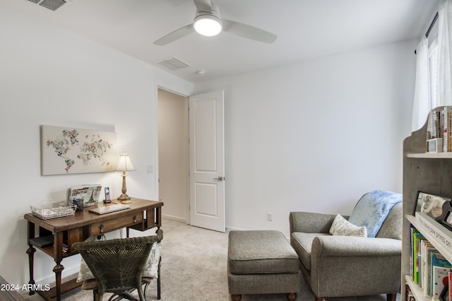 carpeted office space featuring ceiling fan