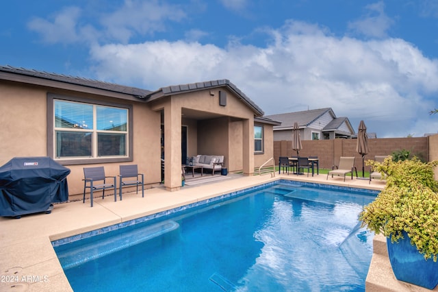 view of swimming pool featuring an outdoor living space, a grill, and a patio area