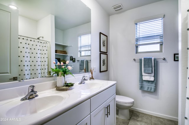 bathroom featuring tile patterned flooring, a shower with curtain, vanity, and toilet