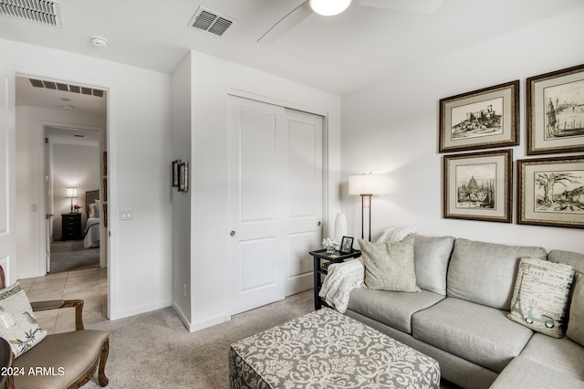 living room with light colored carpet and ceiling fan