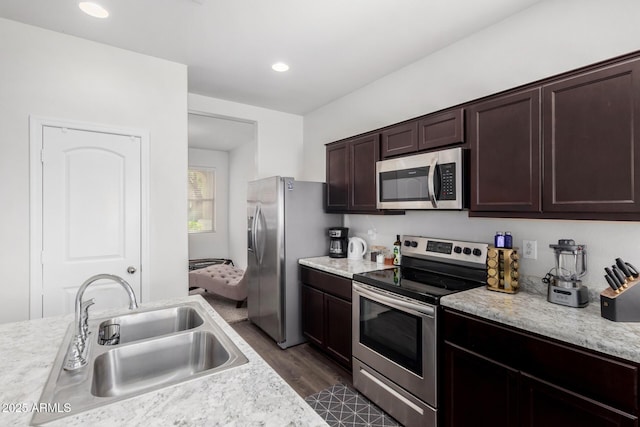 kitchen with stainless steel appliances, light countertops, and a sink