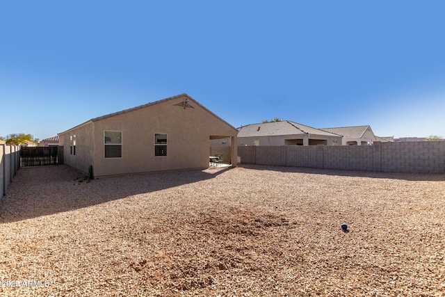 rear view of house with a patio area, a fenced backyard, and stucco siding