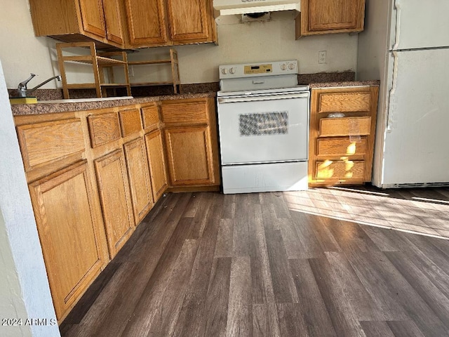 kitchen with dark hardwood / wood-style flooring, white appliances, and sink