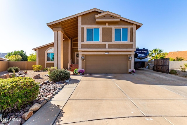 view of front of home featuring fence, a garage, driveway, and stucco siding