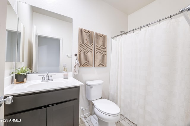 bathroom featuring toilet, vanity, and tile patterned flooring