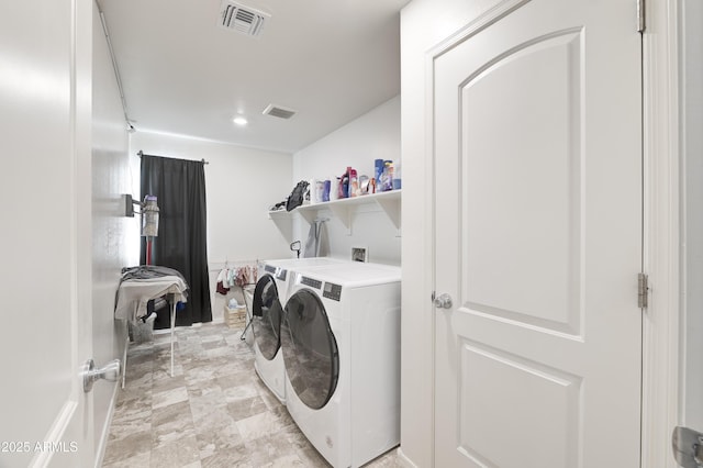 washroom featuring washing machine and clothes dryer