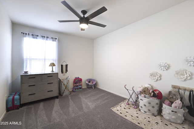 recreation room featuring ceiling fan and dark carpet