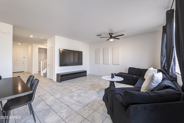 tiled living room with ceiling fan