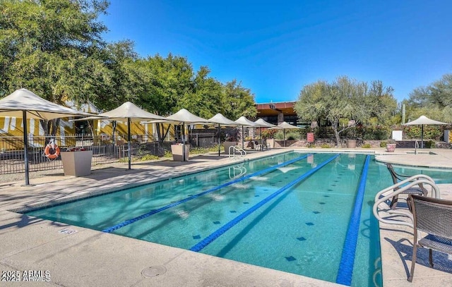 pool featuring fence and a patio