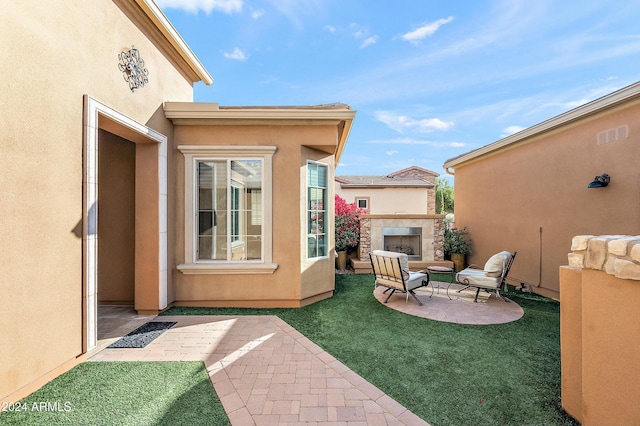 view of patio / terrace with an outdoor fireplace