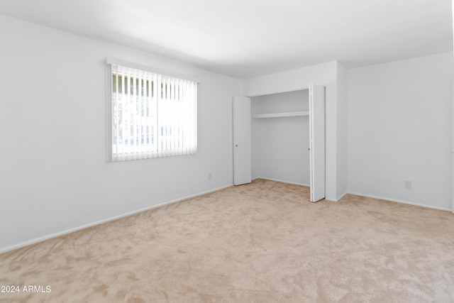 unfurnished bedroom with carpet and a closet