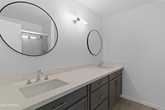 bathroom featuring tile patterned flooring and double sink vanity