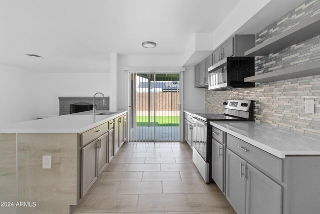 kitchen with gray cabinets, decorative backsplash, sink, appliances with stainless steel finishes, and light tile patterned floors