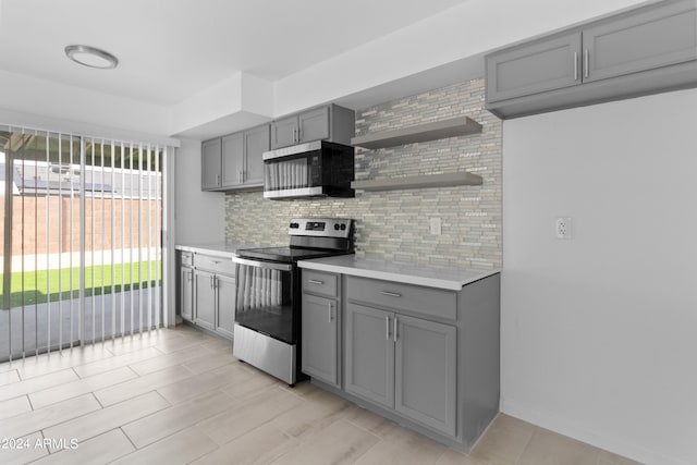 kitchen featuring appliances with stainless steel finishes, tasteful backsplash, and gray cabinetry